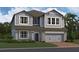 Charming two-story home with blue siding, a stone-accented garage, and a well-manicured lawn at 2672 Great Heron Ave, St Cloud, FL 34773