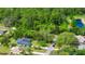 An aerial shot capturing the property's appeal, highlighting its mature trees and proximity to the picturesque waterfront at 275 W 3Rd St, Chuluota, FL 32766