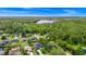 Aerial shot of a well-situated home near a serene lake, embraced by the beauty of a lush green forest at 275 W 3Rd St, Chuluota, FL 32766