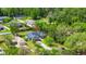 The aerial view of a charming home nestled within established landscaping, with a yard and privacy fence at 275 W 3Rd St, Chuluota, FL 32766