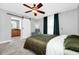 Comfortable bedroom showcasing a barn door leading to bathroom and a ceiling fan at 275 W 3Rd St, Chuluota, FL 32766