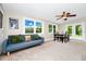 Comfortable room featuring a dining set, with an adjacent sofa area, and an abundance of natural light at 275 W 3Rd St, Chuluota, FL 32766