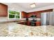 Well-equipped kitchen featuring updated appliances, granite countertops, and natural light at 275 W 3Rd St, Chuluota, FL 32766