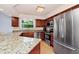 Modern kitchen with stainless steel appliances, granite countertops, and ample cabinet space at 275 W 3Rd St, Chuluota, FL 32766