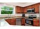 Modern kitchen featuring stainless steel appliances, granite countertops, and ample cabinet space at 275 W 3Rd St, Chuluota, FL 32766