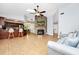 Bright living space featuring an open kitchen, cozy fireplace, tile flooring, and modern ceiling fan at 275 W 3Rd St, Chuluota, FL 32766