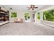 Spacious living room with abundant natural light from large windows and a cozy couch with patterned pillows at 275 W 3Rd St, Chuluota, FL 32766