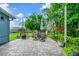 Paver patio is furnished with an outdoor dining set and surrounded by lush landscaping at 275 W 3Rd St, Chuluota, FL 32766
