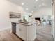 Bright kitchen featuring an island with granite countertops and a view into the living area at 2824 Sw 166Th Ln, Ocala, FL 34473