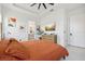 Tranquil main bedroom featuring a ceiling fan, ensuite bathroom, and neutral tones at 2905 Tupelo Loop, St Cloud, FL 34772