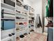 Spacious walk-in closet with custom shelving and an organized display of shoes and accessories at 2905 Tupelo Loop, St Cloud, FL 34772