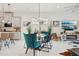 Open-concept dining area featuring stylish decor, modern light fixtures, and a view of the gourmet kitchen at 2905 Tupelo Loop, St Cloud, FL 34772