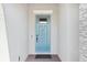 Close up of the entry featuring a modern blue-painted front door with stone accent walls at 2905 Tupelo Loop, St Cloud, FL 34772