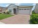 Charming single Gathering home featuring a well-manicured lawn and attached two-car garage at 2905 Tupelo Loop, St Cloud, FL 34772