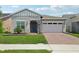 Charming single Gathering home featuring a well-manicured lawn and attached two-car garage at 2905 Tupelo Loop, St Cloud, FL 34772