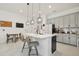 Bright kitchen featuring marble countertops, pendant lighting, and stainless steel appliances at 2905 Tupelo Loop, St Cloud, FL 34772