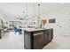 Open kitchen with island seating flows seamlessly into the dining and living area at 2905 Tupelo Loop, St Cloud, FL 34772