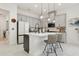 Spacious kitchen with stainless steel appliances, marble countertops, and modern pendant lighting at 2905 Tupelo Loop, St Cloud, FL 34772