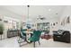 Bright and airy living space showcasing a dining area, comfortable seating, and access to outdoor living at 2905 Tupelo Loop, St Cloud, FL 34772