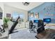 Bright office space with inspiring wall art, dual monitors, and treadmill near the window at 2905 Tupelo Loop, St Cloud, FL 34772