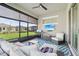 Cozy screened patio with comfortable lounge area, grill, and mounted TV for outdoor entertainment at 2905 Tupelo Loop, St Cloud, FL 34772