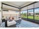 Relaxing screened-in patio featuring an outdoor sofa with a view of the green backyard at 2905 Tupelo Loop, St Cloud, FL 34772