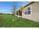 Expansive backyard featuring lush green grass and a covered patio area, perfect for outdoor living at 2936 Sunridge Loop, St Cloud, FL 34771