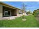 Spacious backyard with a covered patio, complemented by a well-maintained lawn and young trees at 2936 Sunridge Loop, St Cloud, FL 34771
