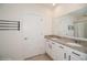 Bathroom featuring double sinks with granite countertops and a full-sized mirror at 2936 Sunridge Loop, St Cloud, FL 34771