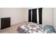 Neutral bedroom featuring a bed with a quilt and dark curtains at 2936 Sunridge Loop, St Cloud, FL 34771