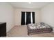 Neutral bedroom featuring a bed with a quilt and dark curtains at 2936 Sunridge Loop, St Cloud, FL 34771