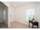 Bright entryway featuring neutral tile floors, a table next to a window, and a white front door at 2936 Sunridge Loop, St Cloud, FL 34771