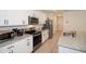 Stylish kitchen featuring granite counters, stainless steel appliances, and white cabinets at 2936 Sunridge Loop, St Cloud, FL 34771