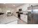 Bright and open kitchen with stainless steel appliances, granite countertops, and white cabinets at 2936 Sunridge Loop, St Cloud, FL 34771