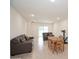 Bright living room with tile floors, couch, and dining table for flexible living at 2936 Sunridge Loop, St Cloud, FL 34771