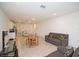 Open-concept living space with tile flooring, a couch, and kitchen in the background at 2936 Sunridge Loop, St Cloud, FL 34771