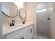 Bright bathroom featuring double sink with a modern shower and tile at 3042 Herold Dr, Orlando, FL 32805