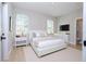 Comfortable bedroom features a large bed, neutral colors, and easy access to an adjacent bathroom at 3042 Herold Dr, Orlando, FL 32805