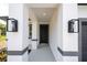 Elegant entryway features stylish sconces, neutral paint, a gray accent stripe, and a sleek front door at 3042 Herold Dr, Orlando, FL 32805