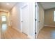 Hallway with wood floors leading to multiple rooms and a window at 3042 Herold Dr, Orlando, FL 32805