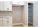 A modern kitchen with white cabinets, stylish backsplash, and convenient access to a pantry at 3042 Herold Dr, Orlando, FL 32805