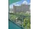 City high-rise view from the balcony with green trees in the foreground at 322 E Central Blvd # 908, Orlando, FL 32801
