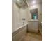 Bathroom featuring tub/shower with tile surround, neutral walls and vanity with mirror at 322 E Central Blvd # 908, Orlando, FL 32801