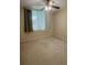 A cozy bedroom with cityscape views, a ceiling fan, and neutral carpet at 322 E Central Blvd # 908, Orlando, FL 32801