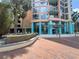 Beautiful condominium building with a water feature and towering palm trees enhancing the curb appeal at 322 E Central Blvd # 908, Orlando, FL 32801