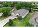 Expansive aerial perspective of a home with a manicured lawn and landscaping, complemented by a long driveway at 3281 Saloman Ln, Clermont, FL 34711