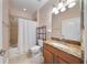 Bathroom featuring a granite vanity top, with a shower and tub combo at 3281 Saloman Ln, Clermont, FL 34711