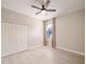 Simple bedroom with a closet, window with curtain, and modern hardwood floors, providing comfort at 3281 Saloman Ln, Clermont, FL 34711