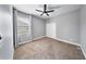 Bedroom with neutral walls, ceiling fan, window with drapes, and carpeted floor at 3281 Saloman Ln, Clermont, FL 34711
