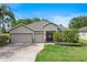 Beautiful single Gathering home with a well-maintained lawn, three-car garage, and a red brick driveway at 3281 Saloman Ln, Clermont, FL 34711